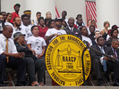 Dream Defenders executive director Phillip Agnew speaks at the NAACP rally at the Capitol on Friday. Behind him are protesters who have camped out at the governor's office for four days. Photo by Ryan Ray.