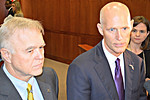 FDLE Commissioner Gerald Bailey, left, and Gov. Rick Scott talk with reporters after Tuesday's Cabinet meeting where Bailey reported a steep drop in the state's crime rate. Photo by Bill Cotterell.