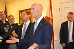 Gov. Rick Scott talks with reporters Tuesday about in-state tuition for undocumented students, as Lt. Gov. Carlos Lopez Cantera stands to his right. Photo by Bill Cotterell.
