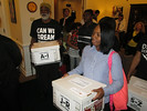 Dream Defenders and other opponents of ethnic-centric achievement goals for measuring student progress haul boxes of petitions into Gov. Rick Scott's office on Monday. Photo by Bill Cotterell