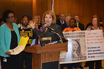 Rep. Janet Cruz, at the lectern with Sen. Arthenia Joyner to the left, discusses raising the minimum wage and assuring enforcement of equal-pay laws. Photo by Bill Cotterell.
